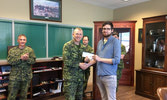 Mr. Travis Taylor receiving his scholarship from the Commanding Officer.