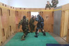 Cpl Gray defends himself from two CQC Instructors in the kill house as his course mates cheer him on. Photo: Cpl Sawyer