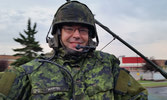 Coyote gunner Cpl Martel smiles after watching cars and pedestrians react to the sight of two army vehicles moving through the streets of Edmonton.