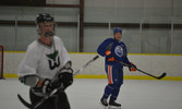 Corporal Colin Roselle and Andrew Ference on the ice.