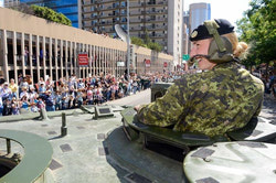 WO Melanie Parent waves to the enthusiastic crowd during the Calgary Stampede Parade.