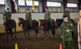 Sgt Kruhlak stands in front of the riders prepared to put on a ride demonstration as the VIP guests arrive