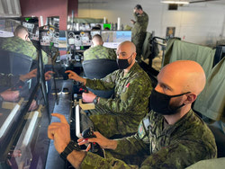 Sgt Balfour (right) and Cpl Cyr (center) conducting fire orders practicing for their simulator test.