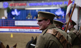 A sweaty Cpl Germann smiling as he prepares to ride in WWI dress
